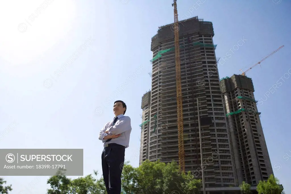 Businessman in front of a building under construction