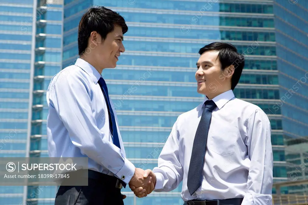 Businessman shaking hands in an urban scene