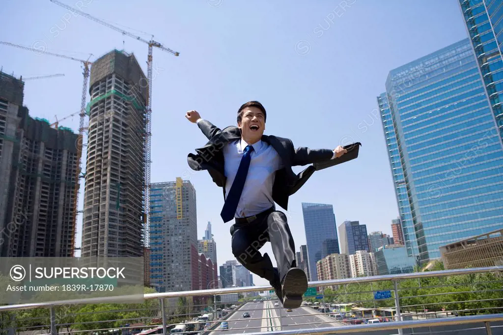 Happy businessman in an urban scene