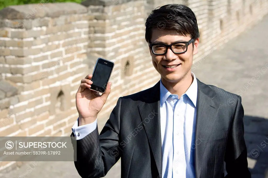 Businessman using a mobile phone on the Great Wall