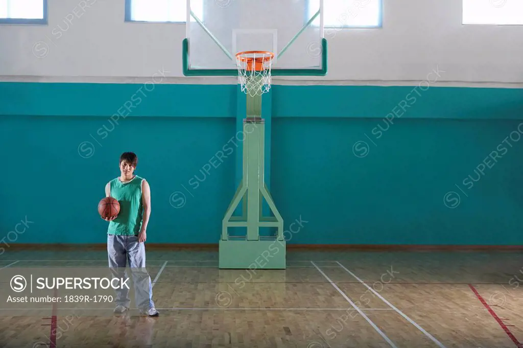 Teenage Boy Holding Basketball