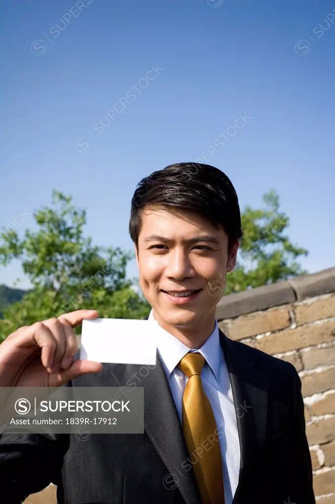 Businessman holding a name card on the Great Wall