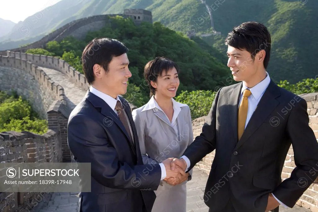 Businessmen shaking hands on the Great Wall