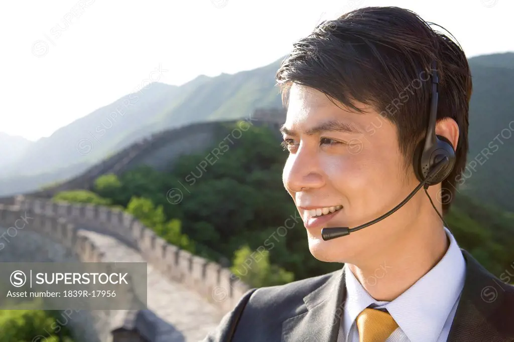 Businessman with headsets on the Great Wall