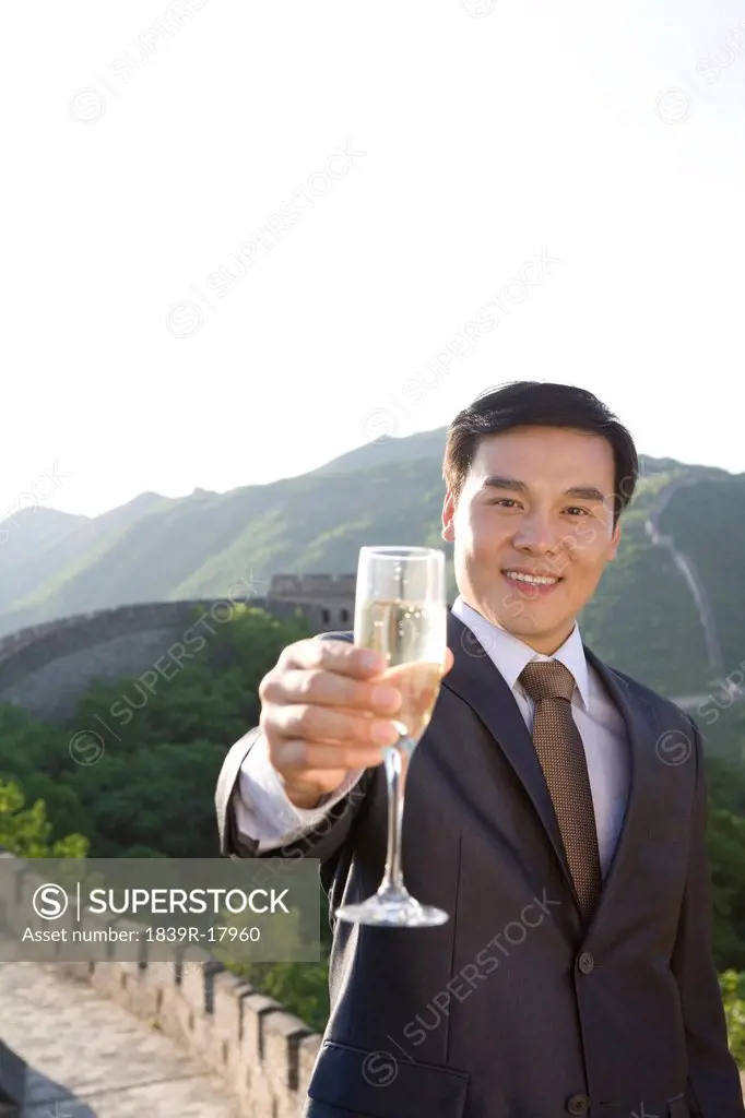 Businessman having champagne on the Great Wall