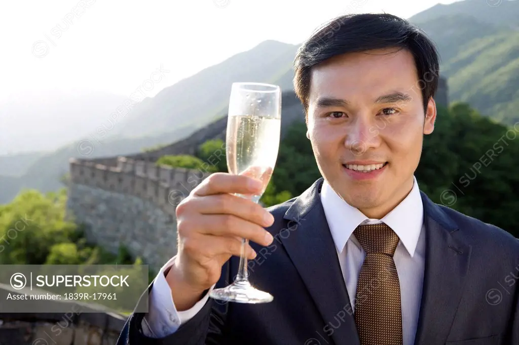 Businessman having champagne on the Great Wall