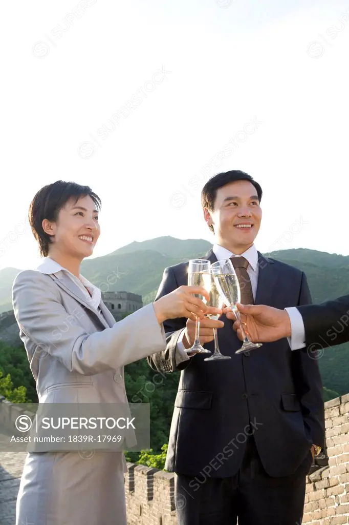 Businesspeople having champagne on the Great Wall