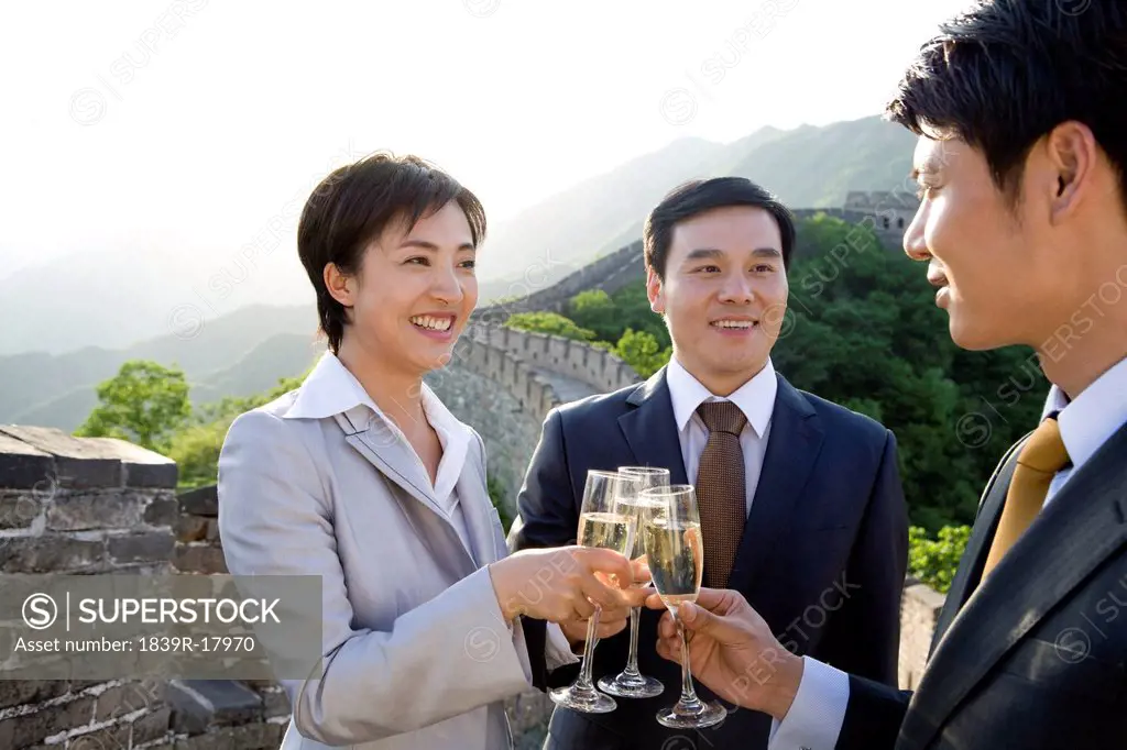Businesspeople having champagne on the Great Wall
