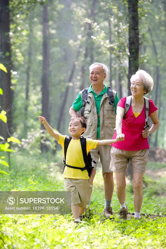 Little boy with his grandparents hiking