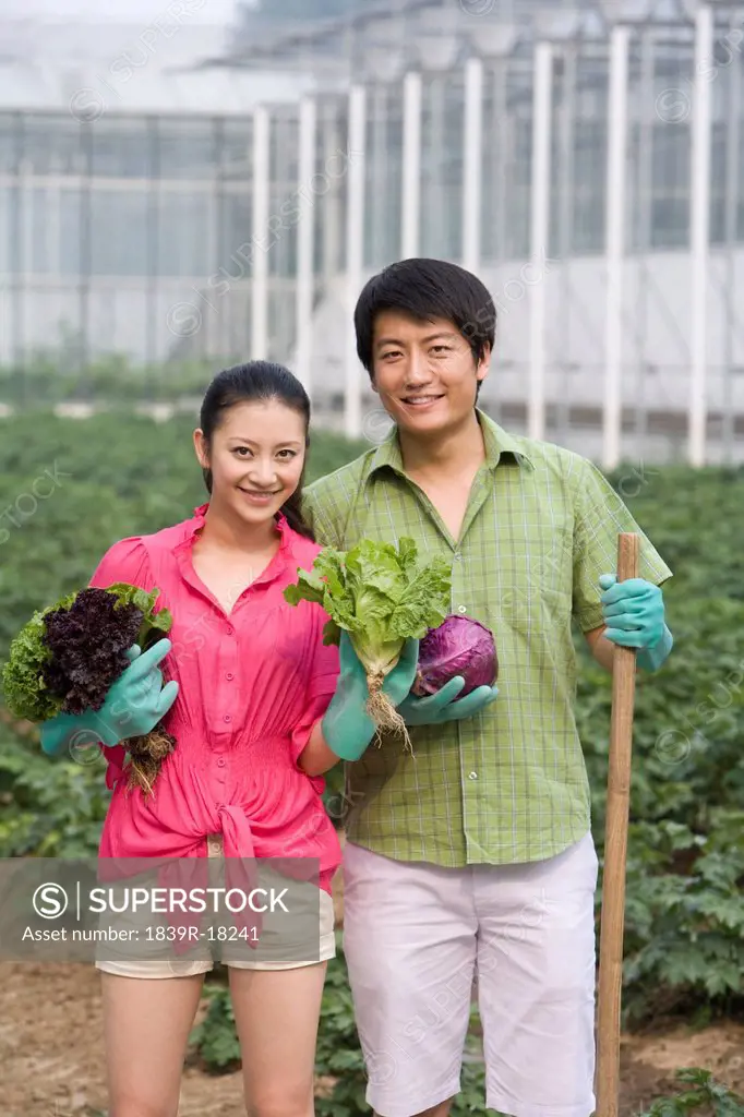 Young couple gardening in farm