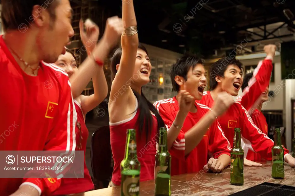 Patriotic Young People In A Bar Celebrating Win