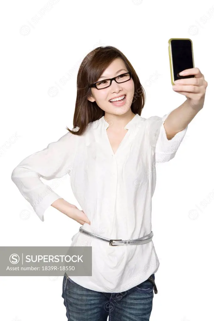 Portrait of Young Woman Taking a Photograph of Herself