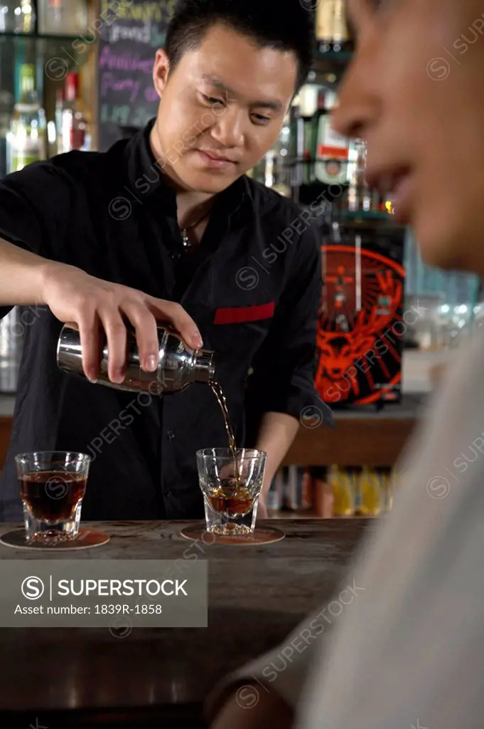 Barman Pouring Drinks