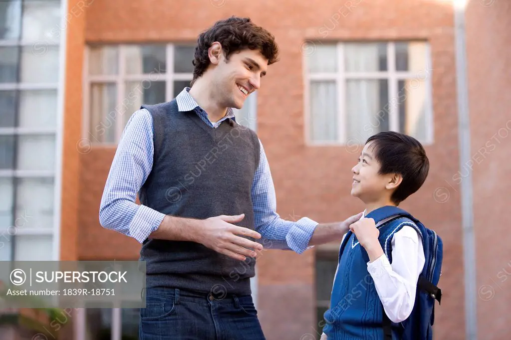 Teacher talking with a student on campus