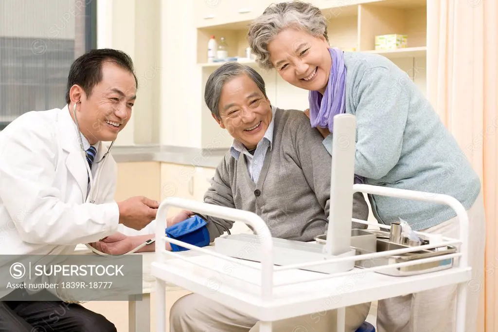 Senior Man Having His Blood Pressure Tested by a Doctor