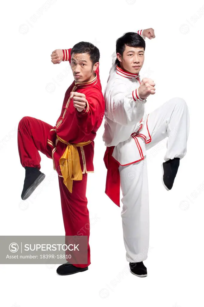 Focused Men Doing Martial Arts in Chinese Clothing