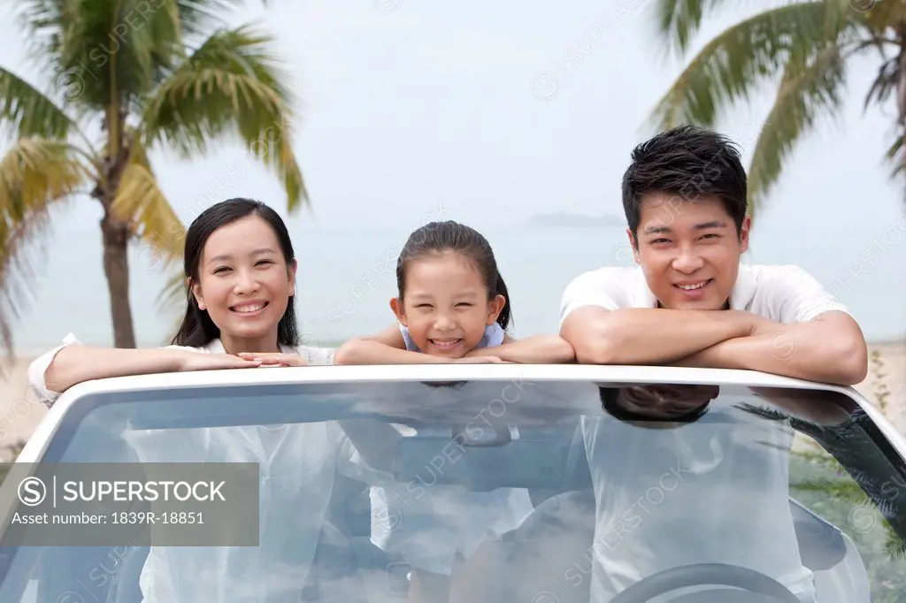 Happy Family Posing in a Convertible
