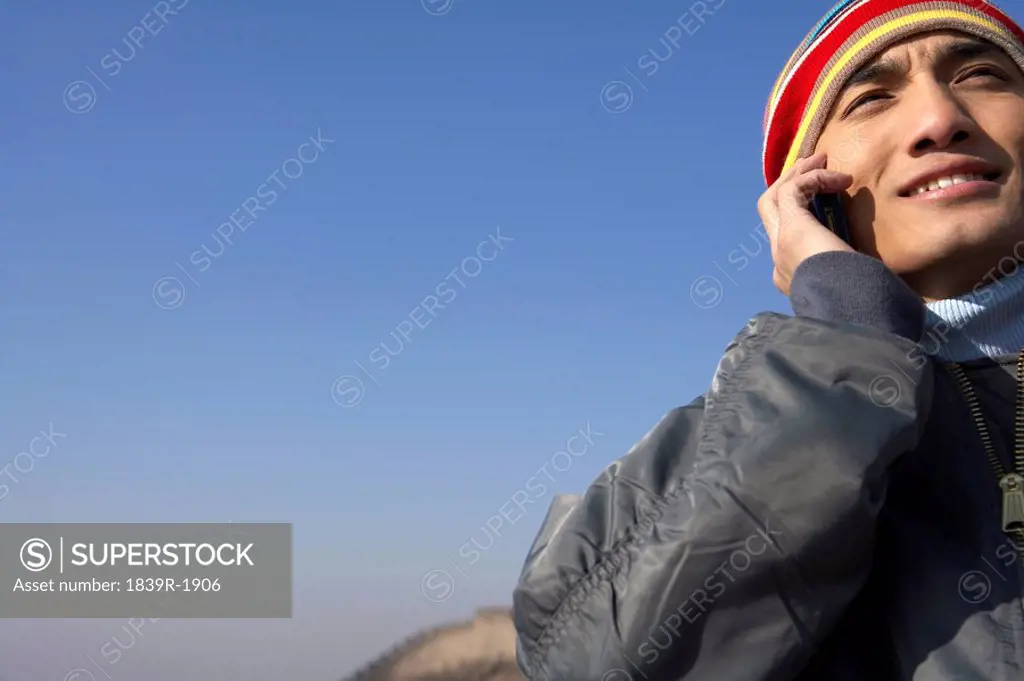 Man Talking On His Cellphone On The Great Wall Of China