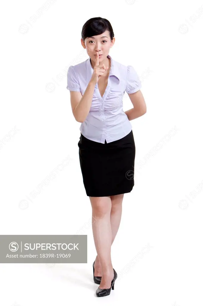 Portrait of a Businesswoman With Finger on Her Lips
