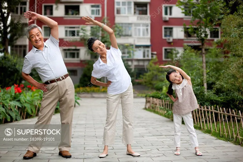 Chinese girl with grandparents exercising