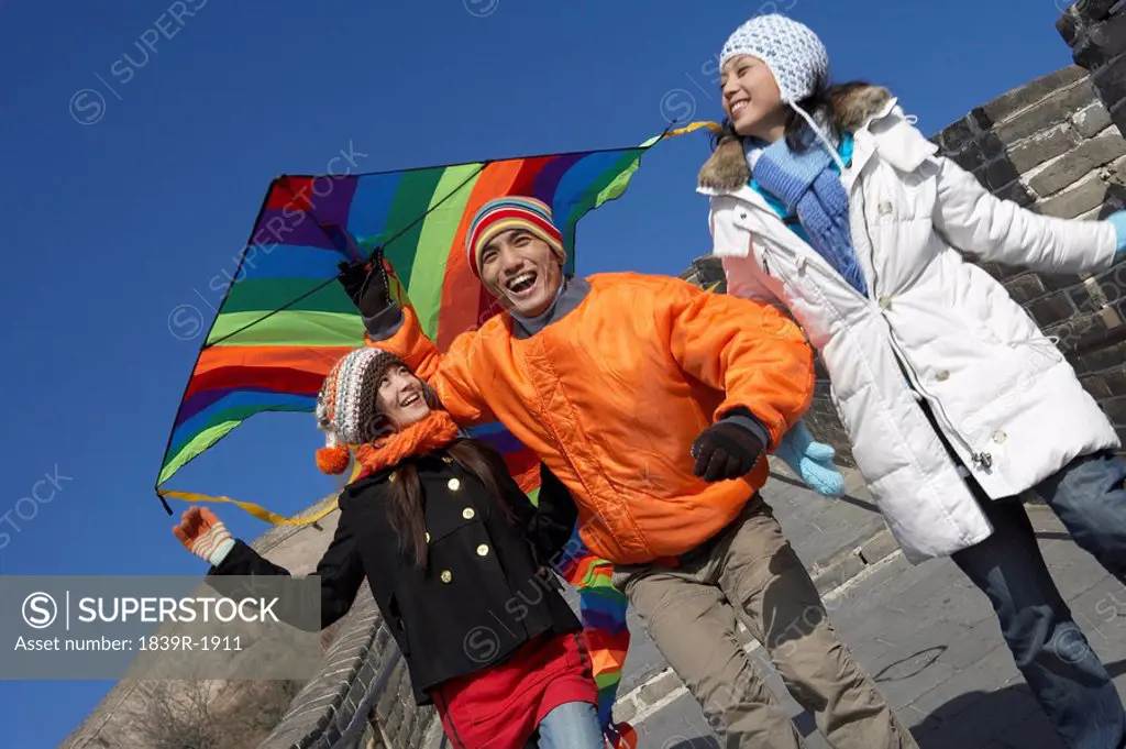 Young People Flying A Kite On The Great Wall Of China