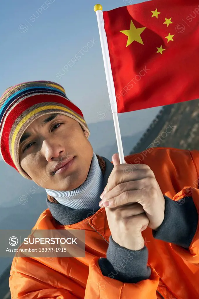 Man Waving A Flag On The Great Wall Of China