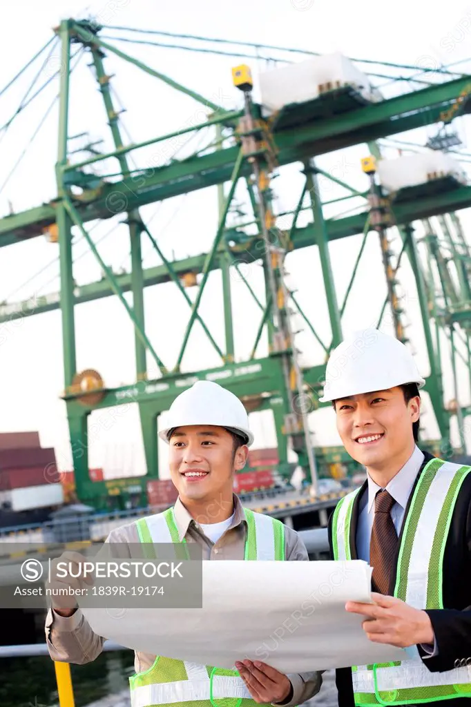 shipping industry professionals looking over blueprints