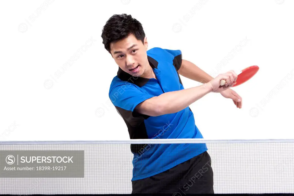 Table tennis player swinging