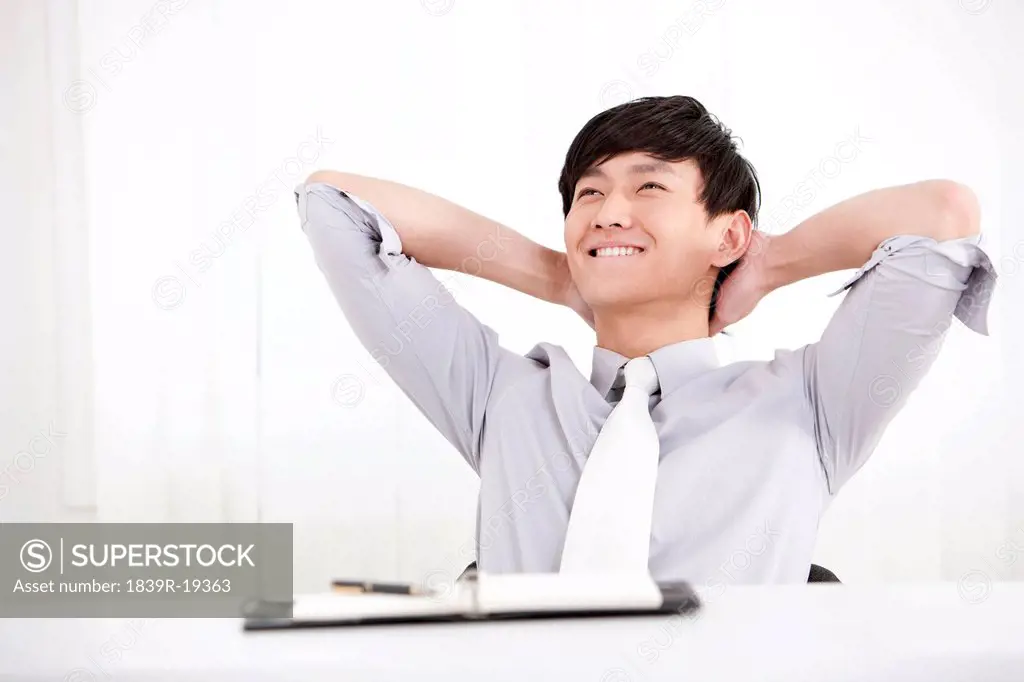 Young businessman taking a break in office