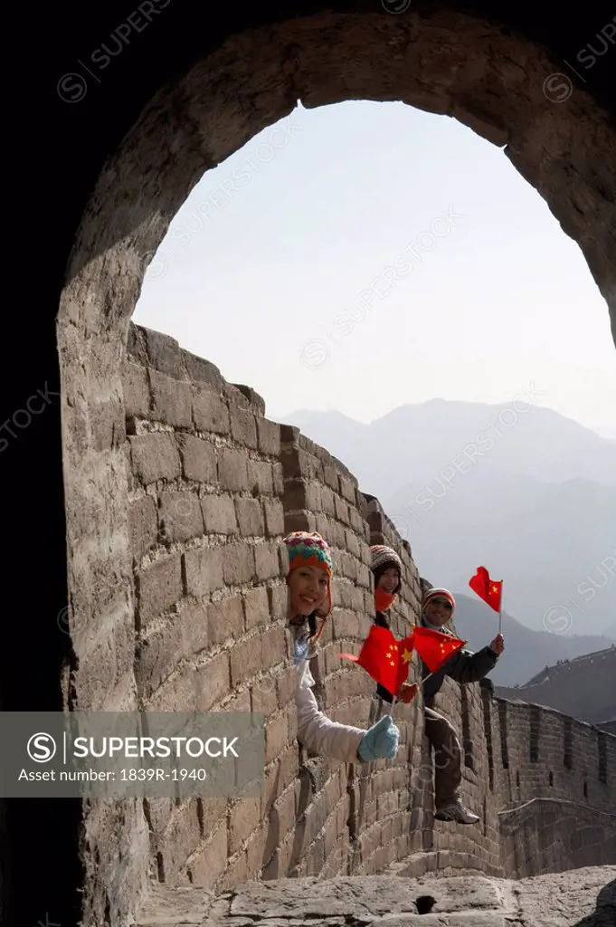 Young People Holding Flags On The Great Wall Of China