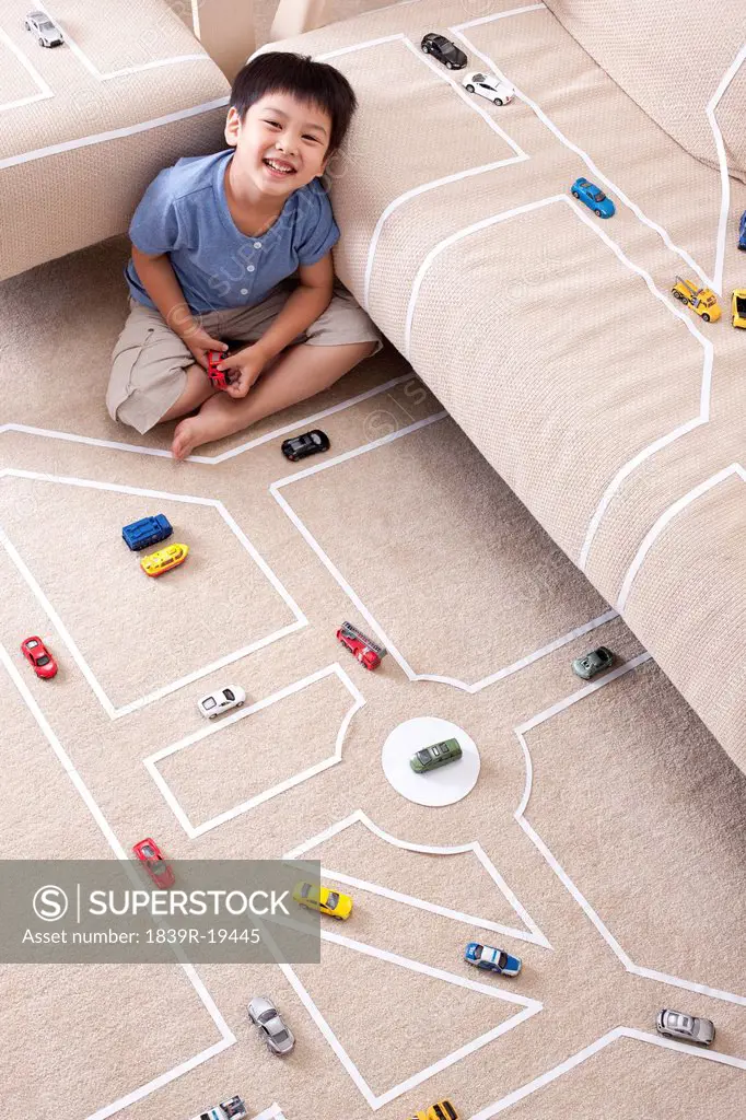 Boy playing toy car at home