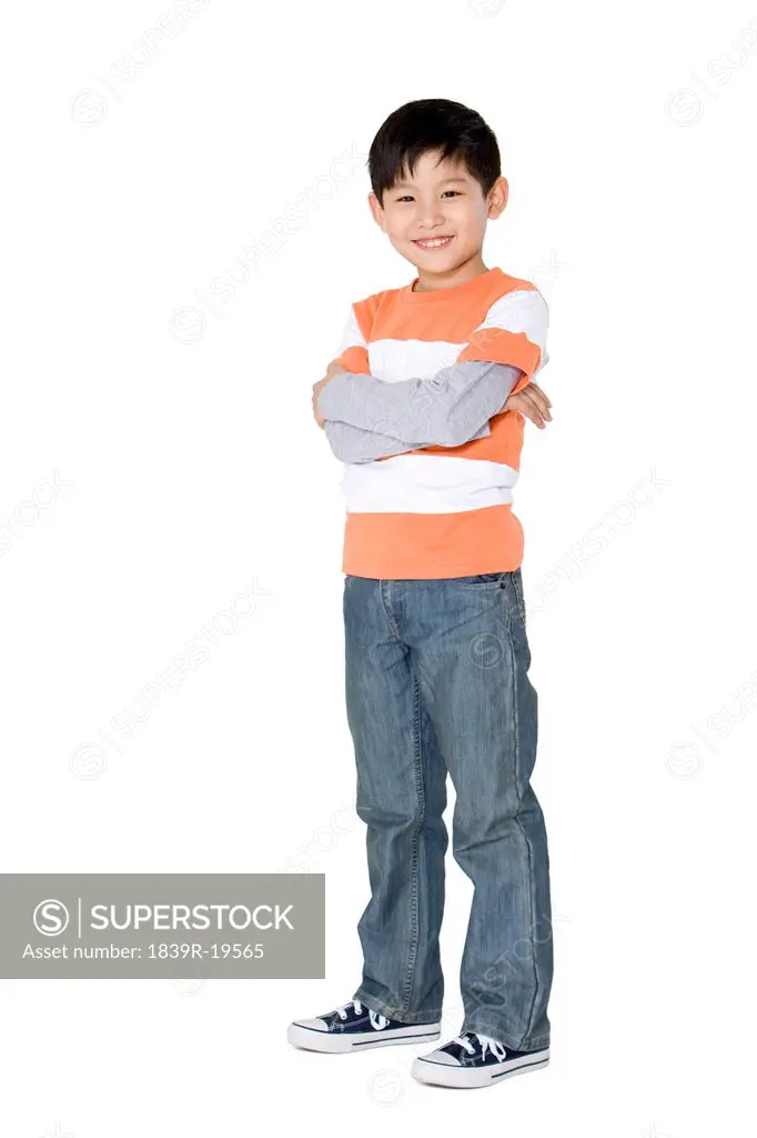 Young boy standing with arms crossed