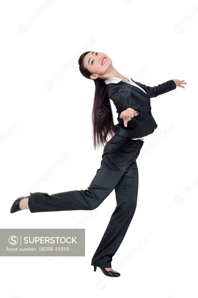 A businesswoman dancing