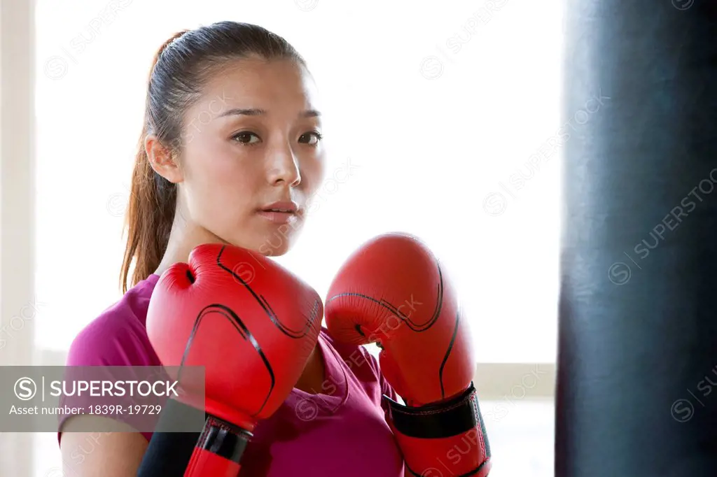 Confident Young Woman in Boxing Gloves
