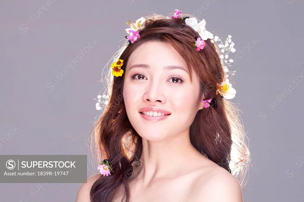 Portrait of a Beautiful Young Woman with Flowers in her Hair