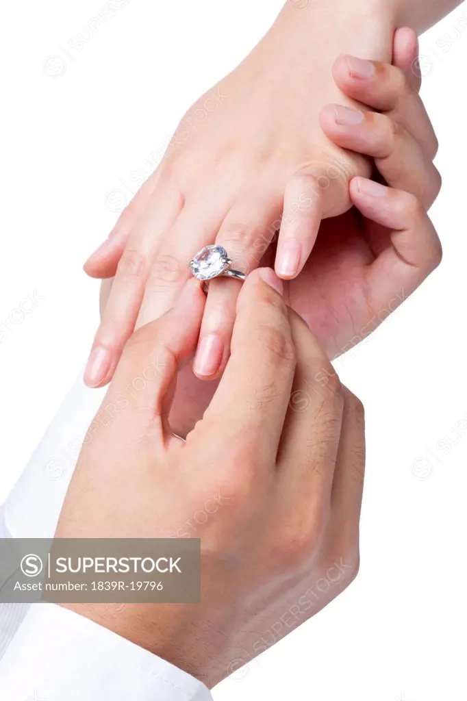 Groom Placing Ring on Bride