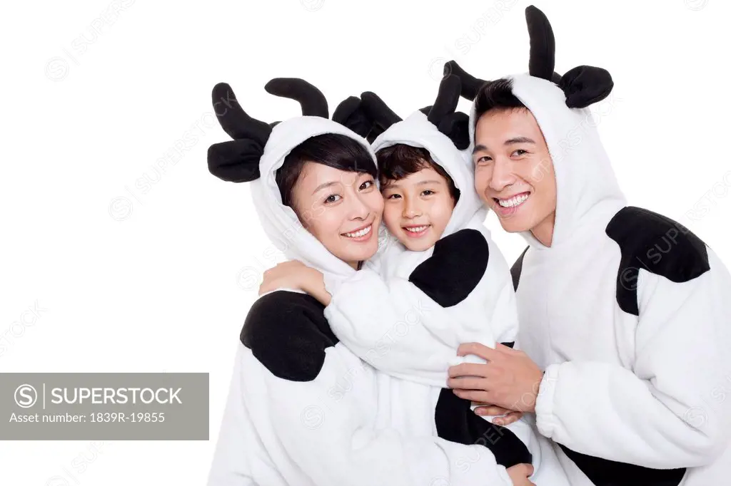 Family in cow costumes hugging