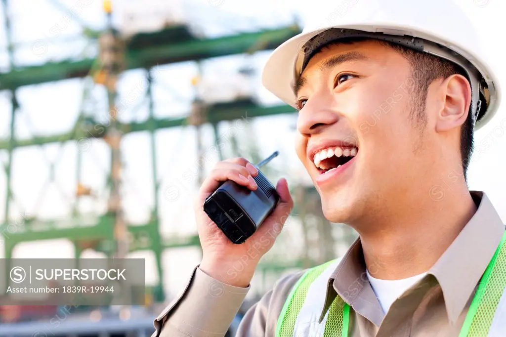 shipping industry worker using a walkie_talkie talking