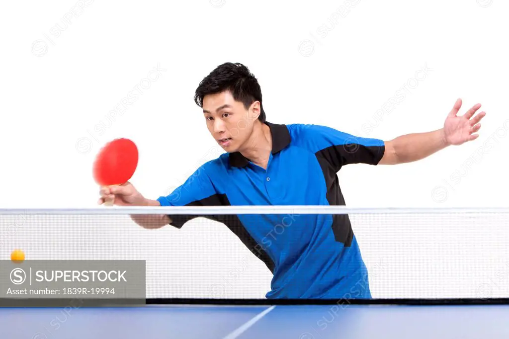 Table tennis player hitting ball