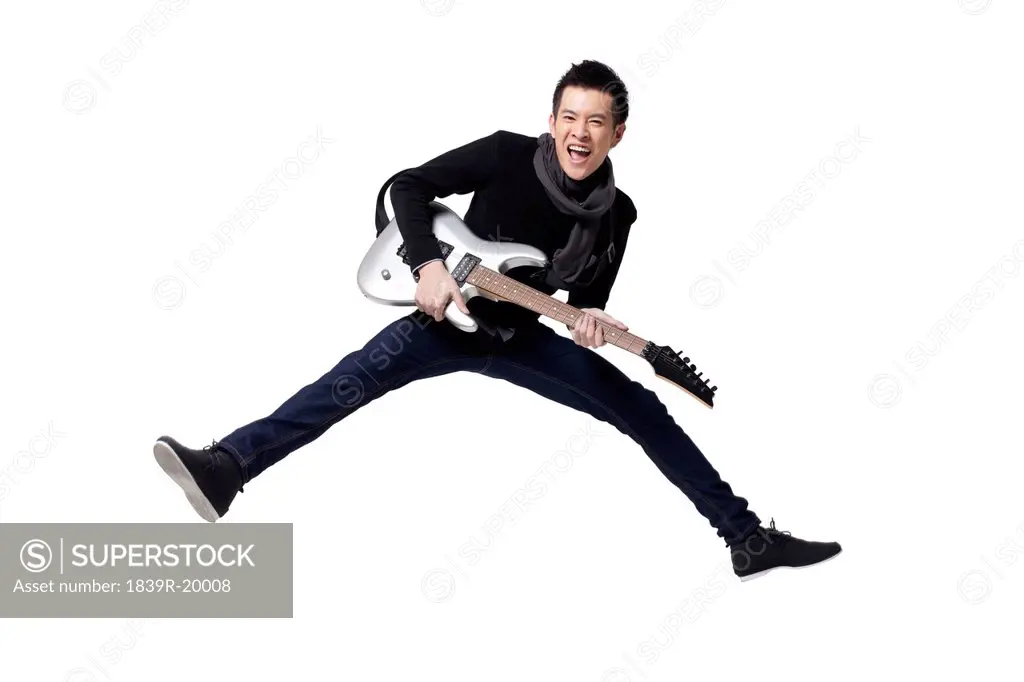 Stylish young man playing guitar