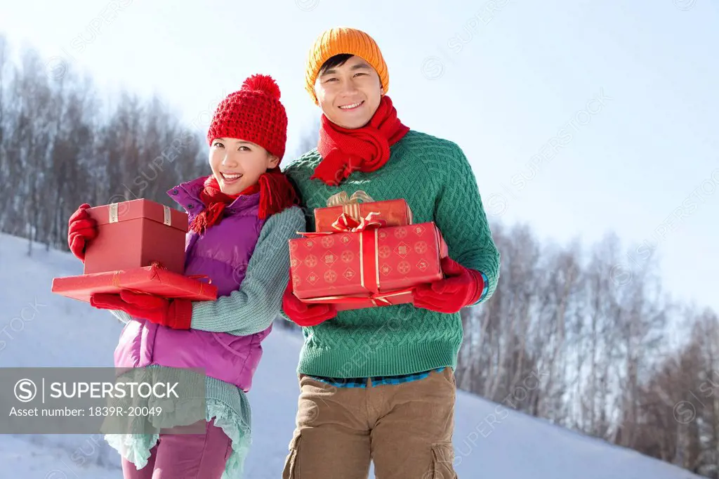 Young people holding gift boxes