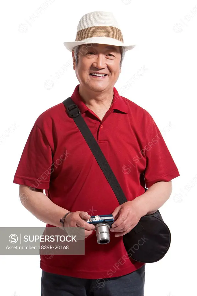 Portrait of senior man holding a camera