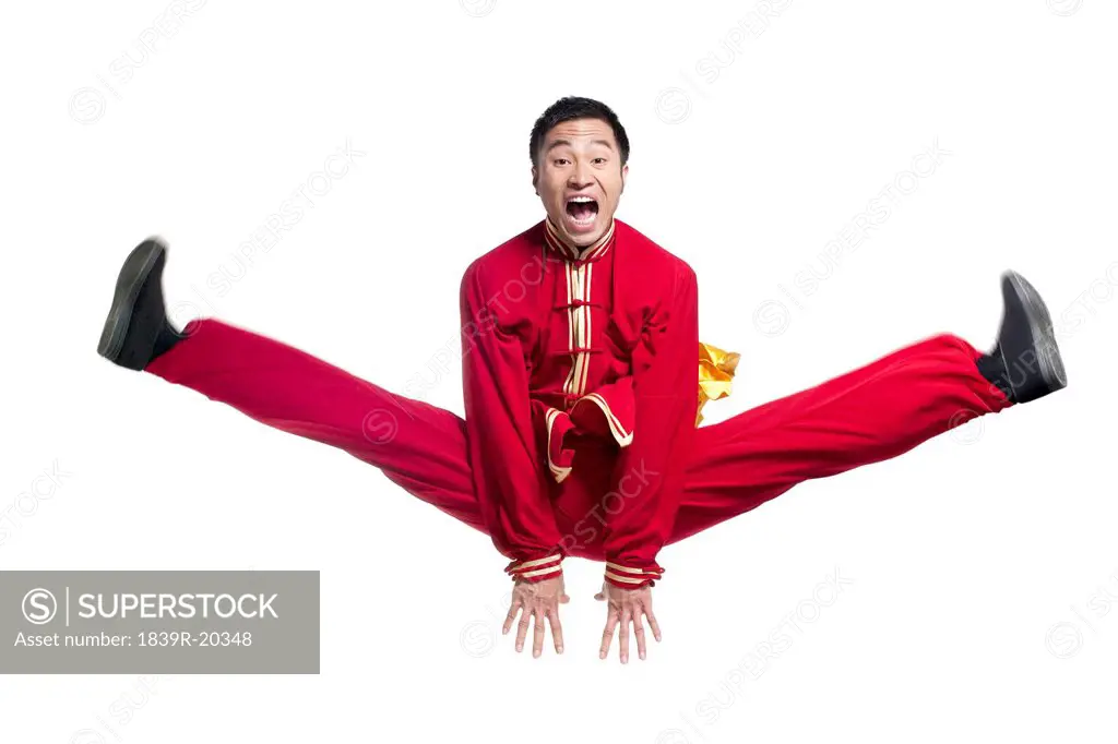 Man in Traditonal Chinese Clothes Jumping in the Air