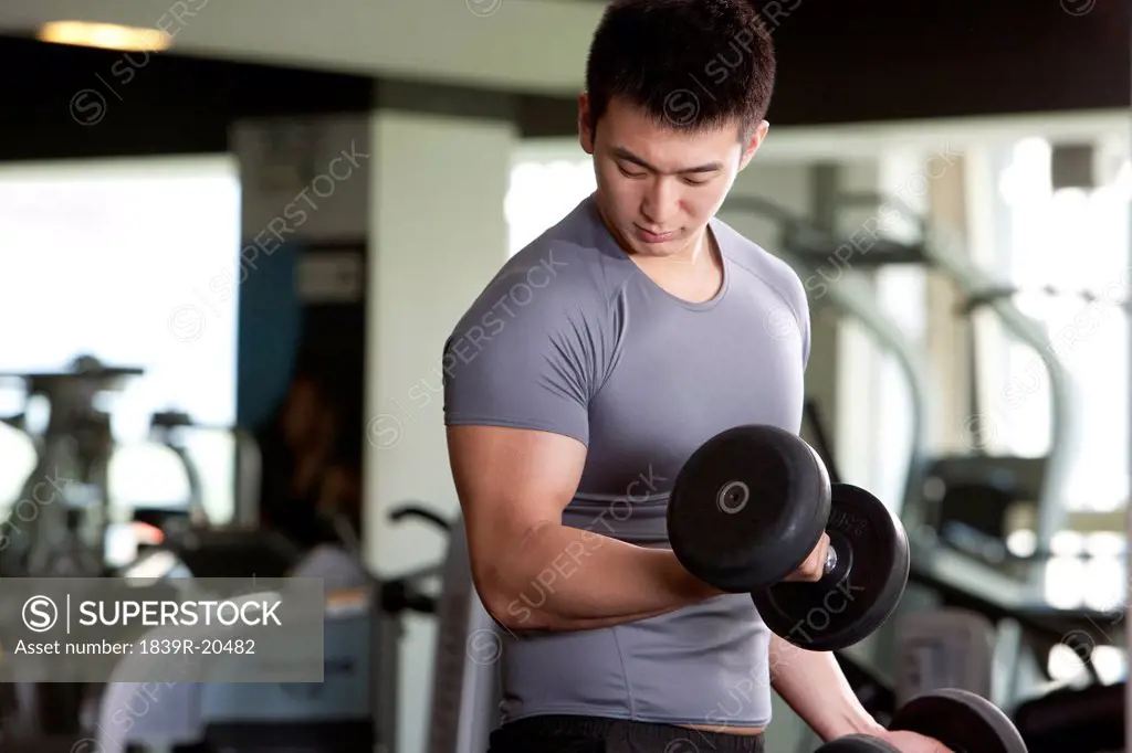 Young Man Lifting Weights