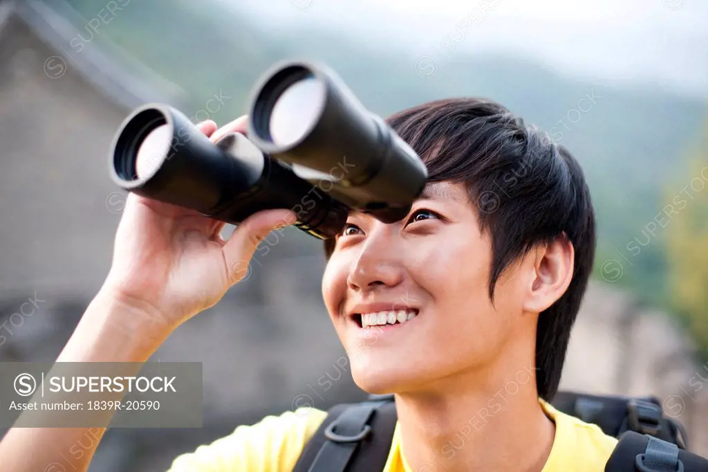 Young people using binoculars on the Great Wall