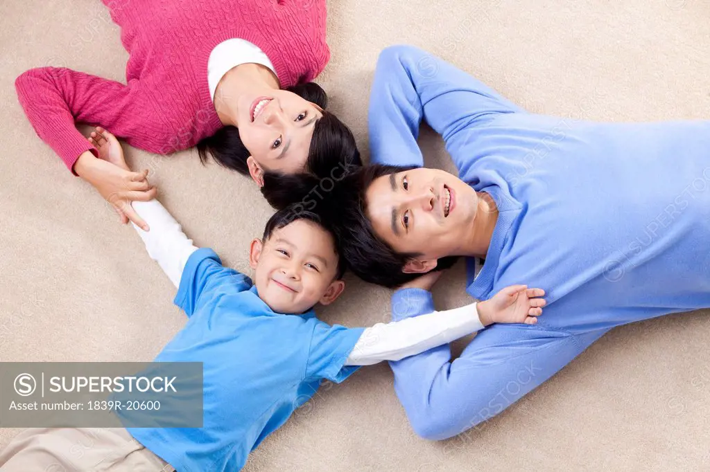 Young Chinese family lying on the floor