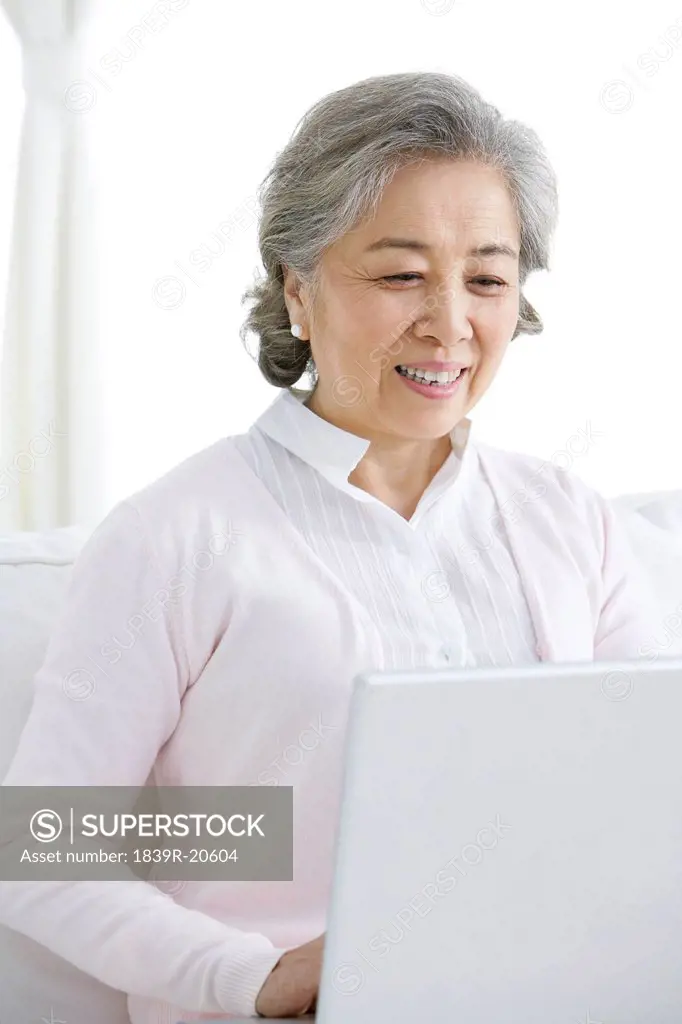 Senior Chinese woman using a laptop