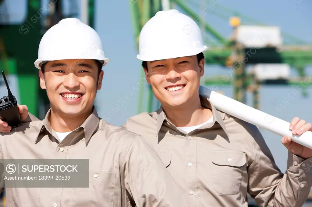 Male shipping industry workers smiling