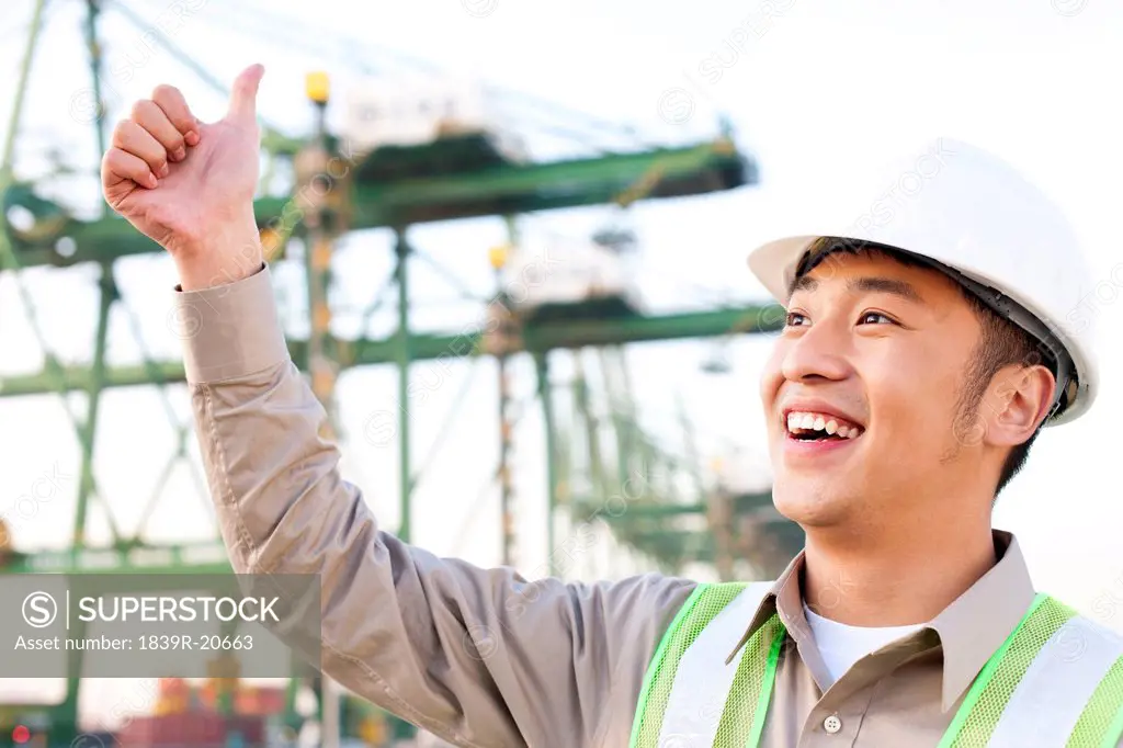 shipping industry worker giving the thumbs_up signal