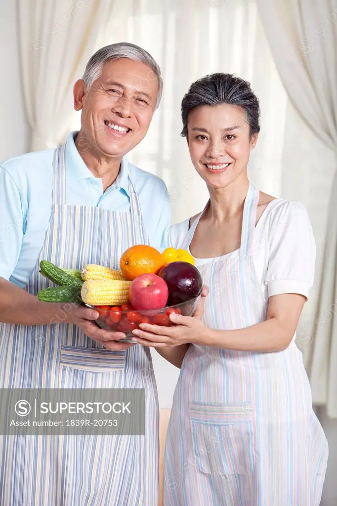 Senior couple with fresh vegetables and fruits
